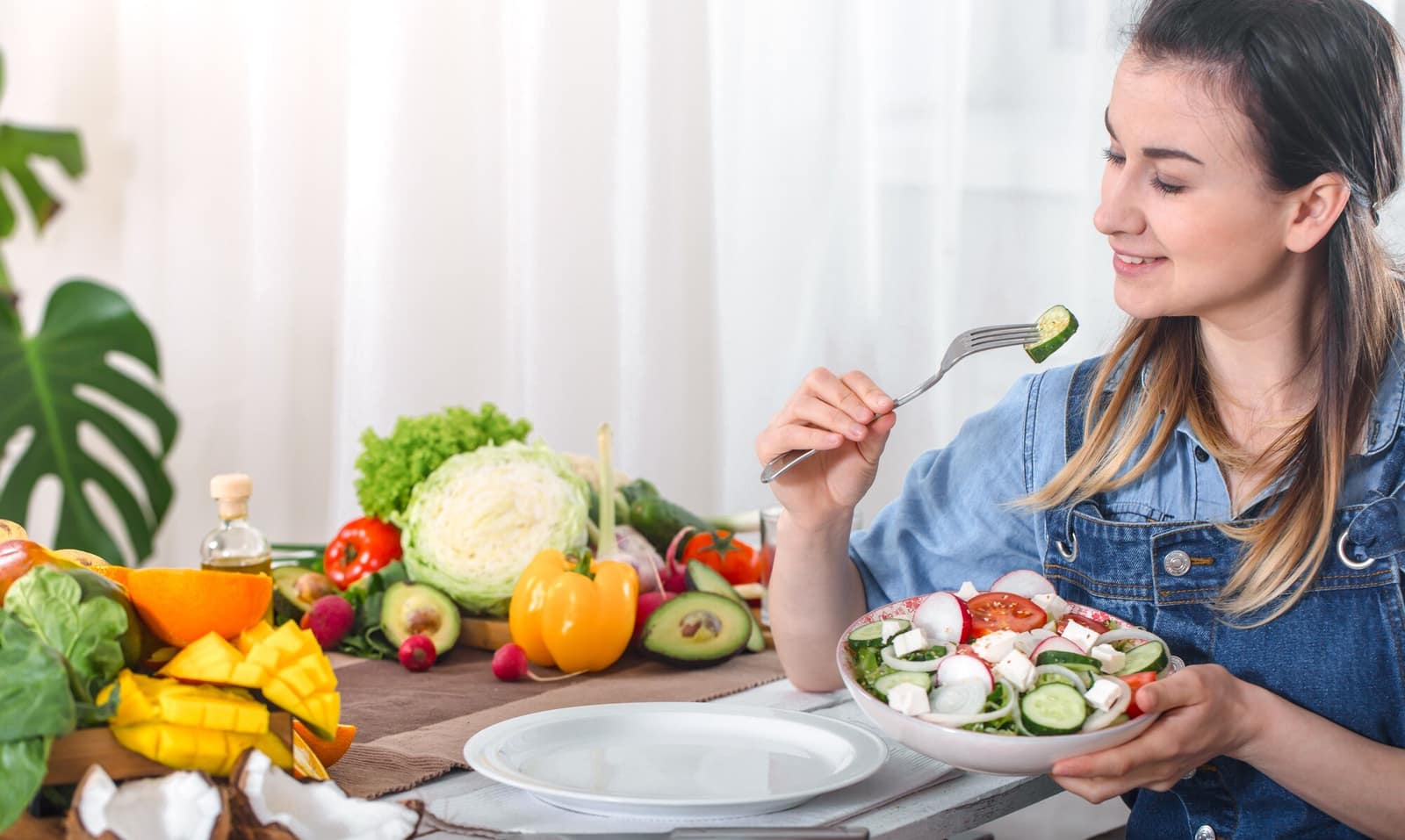 Young woman enjoying a healthy salad with organic vegetables